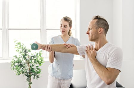 Patient At The Physiotherapy Doing Physical Exercises With His T Therapy Session with Counselor